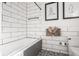 Bright bathroom with subway tile, black and white patterned floor, and modern fixtures for a fresh appeal at 1319 N New Jersey St, Indianapolis, IN 46202