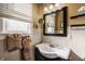 Bathroom with a pedestal sink, modern mirror, and window, offering a blend of classic and contemporary design at 1319 N New Jersey St, Indianapolis, IN 46202