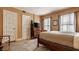 Bedroom with warm yellow walls, hardwood floors, a classic dresser, and a comfortable bed with neutral linens at 1319 N New Jersey St, Indianapolis, IN 46202