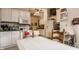 Well-lit kitchen with white cabinets and dining space provides a functional and inviting area for cooking and dining at 1319 N New Jersey St, Indianapolis, IN 46202