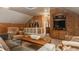 Comfortable living space featuring wood-paneled walls, vaulted ceilings, and plush seating, ideal for lounging at 1319 N New Jersey St, Indianapolis, IN 46202