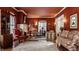 Elegant living room with warm red walls, hardwood floors, and comfortable, patterned sofas at 1319 N New Jersey St, Indianapolis, IN 46202