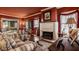 Cozy living room with fireplace, vintage furniture, and view to the dining room at 1319 N New Jersey St, Indianapolis, IN 46202