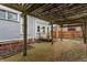 Outdoor patio area with a brick floor and a wooden pergola at 1319 N New Jersey St, Indianapolis, IN 46202