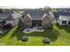Aerial view of a home with a fire pit, patio, grill, and other outdoor features at 16395 La Paloma Ct, Noblesville, IN 46060
