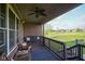 Covered porch with a swing, ceiling fan, and view of the backyard and golf course at 16395 La Paloma Ct, Noblesville, IN 46060