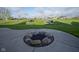 Beautiful back yard with a custom fire pit and manicured landscaping at 16395 La Paloma Ct, Noblesville, IN 46060