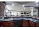 Basement bar with a double sink and dark countertops at 16395 La Paloma Ct, Noblesville, IN 46060