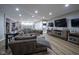 Open concept basement with sectional sofa and large TV at 16395 La Paloma Ct, Noblesville, IN 46060