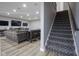 Basement stairs with patterned carpeting and wood railing at 16395 La Paloma Ct, Noblesville, IN 46060