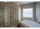 Spa-like bathroom featuring a soaking tub and glass block shower at 16395 La Paloma Ct, Noblesville, IN 46060