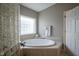 Relaxing bathroom with corner soaking tub and glass block shower at 16395 La Paloma Ct, Noblesville, IN 46060