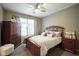 Cozy bedroom with a queen-size bed and wood furniture at 16395 La Paloma Ct, Noblesville, IN 46060