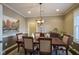 Elegant dining room with a large table, chandelier, and hardwood floors at 16395 La Paloma Ct, Noblesville, IN 46060