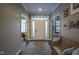 Bright entryway with hardwood floors, decorative bench, and Gathering photos at 16395 La Paloma Ct, Noblesville, IN 46060