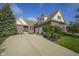 Charming brick home featuring a three-car garage, manicured lawn, and welcoming front entrance at 16395 La Paloma Ct, Noblesville, IN 46060