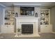 Elegant fireplace with built-in shelving on either side at 16395 La Paloma Ct, Noblesville, IN 46060