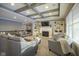 Gathering room with fireplace, built-in shelving, and large windows at 16395 La Paloma Ct, Noblesville, IN 46060