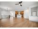 Open concept living room with hardwood floors, kitchen views, and a ceiling fan at 20035 Meadow Neck Rd, Westfield, IN 46074