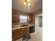 Kitchen with window, wooden cabinets, and stainless steel sink at 2734 Mingo Ct, Indianapolis, IN 46217