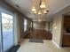 Open-concept living room with a fireplace, ceiling fan, and a sliding glass door at 2734 Mingo Ct, Indianapolis, IN 46217