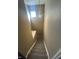 Carpeted stairway with a pendant light and window at 2734 Mingo Ct, Indianapolis, IN 46217