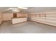 A bonus room with neutral carpeting, a half wall, and built-in shelving ready for organization at 306 Vinewood N Dr, Brownsburg, IN 46112