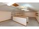 Bright bonus room with shelving, neutral carpeting, and ceiling fan at 306 Vinewood N Dr, Brownsburg, IN 46112