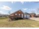 Charming single-story brick home with well-maintained landscaping and a three-car garage at 306 Vinewood N Dr, Brownsburg, IN 46112
