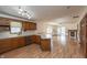 Open-concept kitchen boasts light countertops, wood cabinets and a view into the living space at 306 Vinewood N Dr, Brownsburg, IN 46112