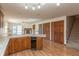 Open-concept kitchen featuring an island and hardwood floors extending into the living area at 306 Vinewood N Dr, Brownsburg, IN 46112