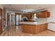 Spacious kitchen features stainless steel appliances and bar seating for casual dining and entertaining at 306 Vinewood N Dr, Brownsburg, IN 46112