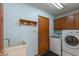 Laundry room featuring a sink and a modern washer and dryer at 306 Vinewood N Dr, Brownsburg, IN 46112
