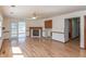 Living room with hardwood floors, fireplace, and natural light from the sliding doors to the sunroom at 306 Vinewood N Dr, Brownsburg, IN 46112