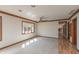 Well-lit living room with hardwood floors, and a connecting view to the dining area at 306 Vinewood N Dr, Brownsburg, IN 46112
