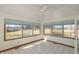 Cozy sunroom features tile flooring, ceiling fan and lots of natural light from surrounding windows at 306 Vinewood N Dr, Brownsburg, IN 46112