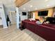 Modern living room with sectional sofa, large TV, and wood accent wall at 3480 S Us Highway 31, Franklin, IN 46131