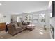 Spacious living room with L-shaped sofa, fireplace, and large windows at 4251 Indigo Walk Ln, Indianapolis, IN 46239