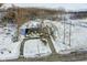 Aerial view of a ranch house on a snowy lot with a detached garage at 4305 Five Points Rd, Indianapolis, IN 46239