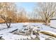 Snowy backyard with trees and partially visible structure at 4305 Five Points Rd, Indianapolis, IN 46239