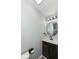Updated bathroom with an oval mirror and dark vanity at 4305 Five Points Rd, Indianapolis, IN 46239