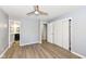 Spacious bedroom with hardwood floors, ceiling fan, and en-suite bathroom at 4305 Five Points Rd, Indianapolis, IN 46239