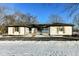 White brick ranch house with black accents, wooden shutters, and a front porch at 4305 Five Points Rd, Indianapolis, IN 46239