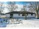 White ranch house with backyard patio, snow on the ground at 4305 Five Points Rd, Indianapolis, IN 46239