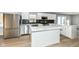 Modern kitchen with white cabinets, quartz countertops, and stainless steel appliances at 4305 Five Points Rd, Indianapolis, IN 46239
