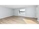 Bright living room with gray walls, wood-look floors, and a large window at 4305 Five Points Rd, Indianapolis, IN 46239