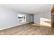 Spacious living room with light gray walls, wood-look floors, and large windows at 4305 Five Points Rd, Indianapolis, IN 46239