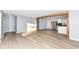 Open concept living room and kitchen with wood beam and vinyl plank flooring at 4305 Five Points Rd, Indianapolis, IN 46239