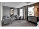 Main bedroom sitting area features two comfy armchairs and a coffee table at 4398 Chital Pl, Greenwood, IN 46143