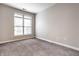 Bright bedroom with large window, neutral walls, and carpet at 450 E Ohio St # 106, Indianapolis, IN 46204